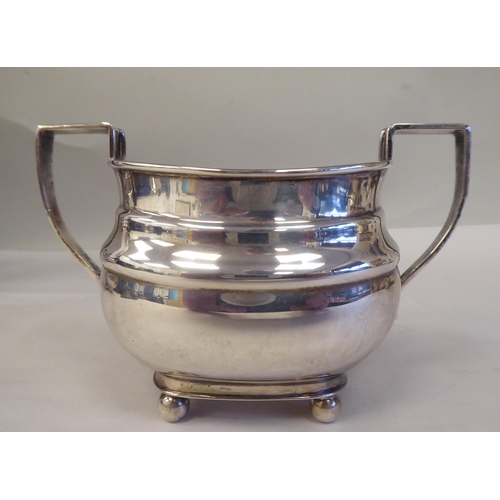 103 - A three piece bachelor's silver tea set of oval ogee form, comprising a teapot with a swept spout, i... 