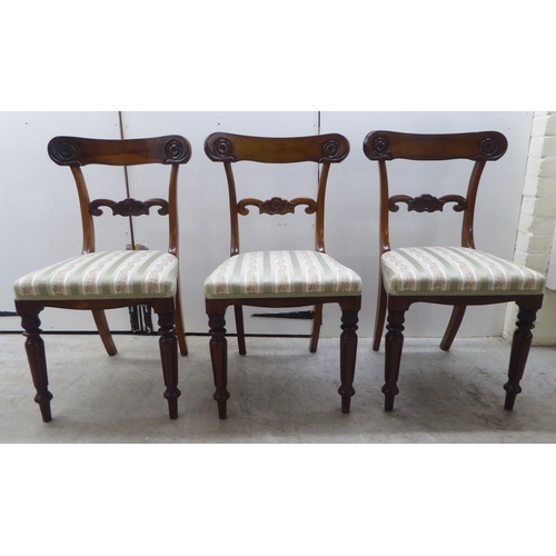 104 - A set of six William IV rosewood framed dining chairs with rosette, scrolled and tulip carved orname... 