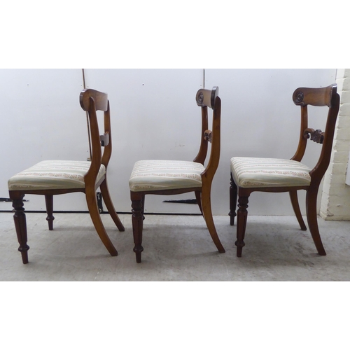 104 - A set of six William IV rosewood framed dining chairs with rosette, scrolled and tulip carved orname... 