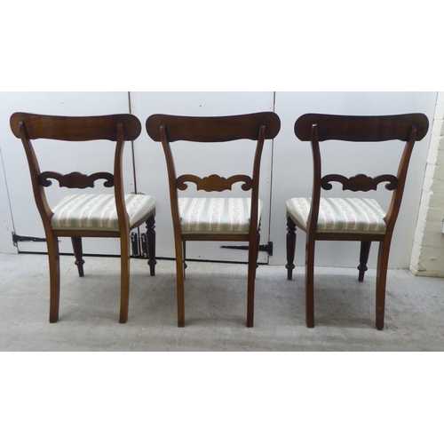 104 - A set of six William IV rosewood framed dining chairs with rosette, scrolled and tulip carved orname... 