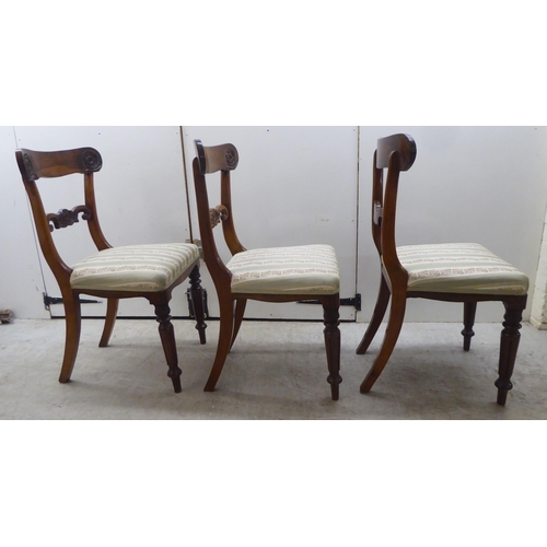 104 - A set of six William IV rosewood framed dining chairs with rosette, scrolled and tulip carved orname... 