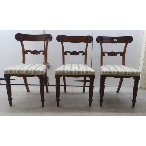 104 - A set of six William IV rosewood framed dining chairs with rosette, scrolled and tulip carved orname... 