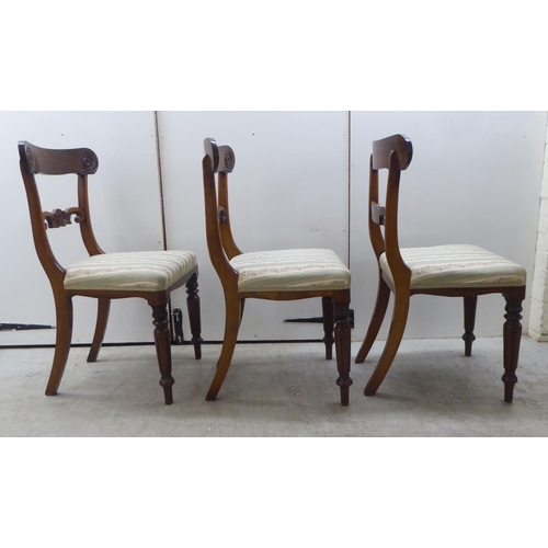 104 - A set of six William IV rosewood framed dining chairs with rosette, scrolled and tulip carved orname... 