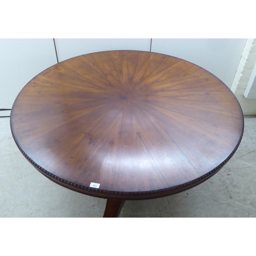 105 - A William IV bead bordered rosewood dining table, the radiating veneered tip-top set on an incurved,... 