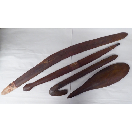 119 - Four Australian/South Pacific native wooden artefacts, viz. a Woomera; a paddle shape throwing club;... 