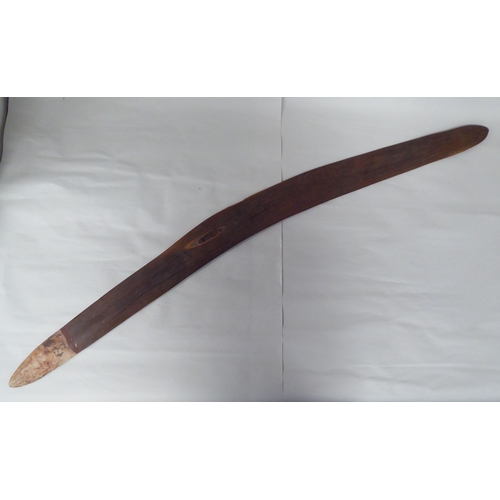 119 - Four Australian/South Pacific native wooden artefacts, viz. a Woomera; a paddle shape throwing club;... 