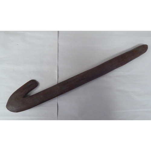 119 - Four Australian/South Pacific native wooden artefacts, viz. a Woomera; a paddle shape throwing club;... 