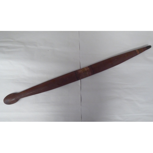 119 - Four Australian/South Pacific native wooden artefacts, viz. a Woomera; a paddle shape throwing club;... 