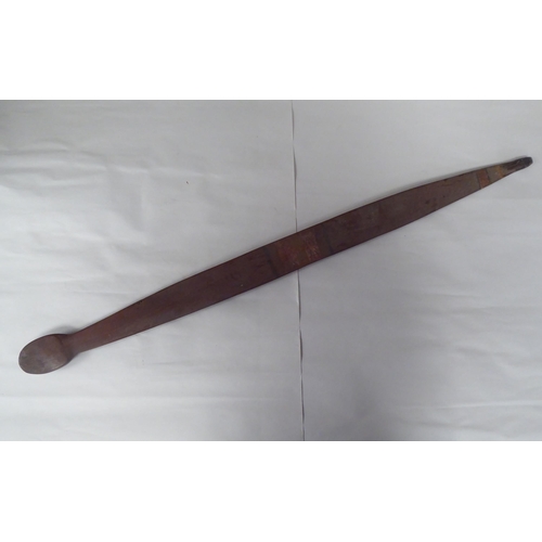 119 - Four Australian/South Pacific native wooden artefacts, viz. a Woomera; a paddle shape throwing club;... 