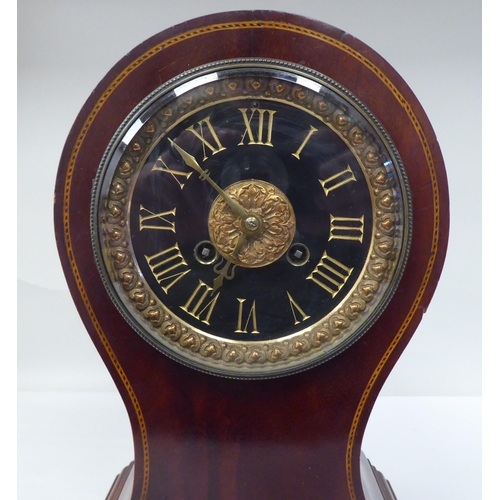 122 - A late Victorian/Edwardian string inlaid mahogany balloon cased mantel clock; the gong strike moveme... 