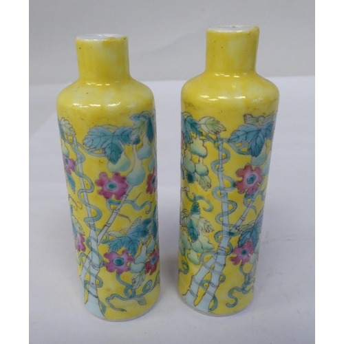 124 - A pair of late 19th/early 20thC Chinese porcelain bottle vases, decorated in coloured famille rose, ... 