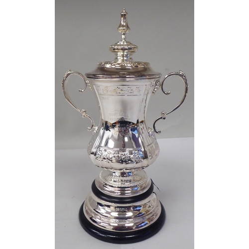 125 - A half-size silver replica of The Football Association Challenge Cup and cover with grape and vine d... 