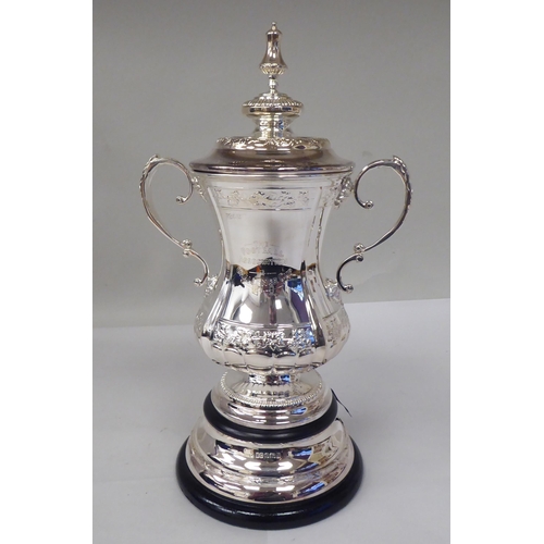 125 - A half-size silver replica of The Football Association Challenge Cup and cover with grape and vine d... 