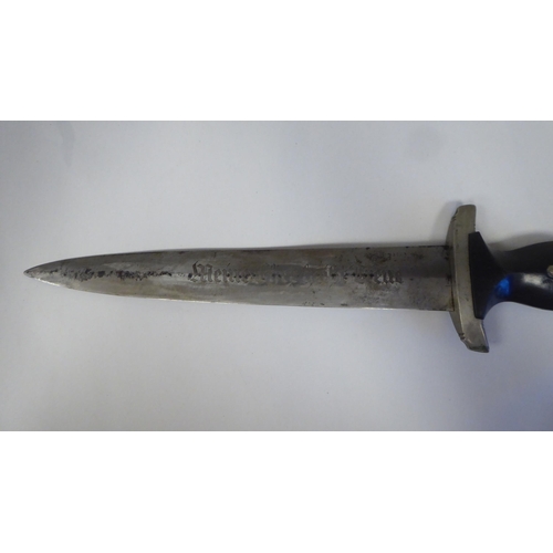 126 - A Third Reich era 'chained' SS dress dagger with a shaped handgrip, nickel-silver mounts and a cross... 