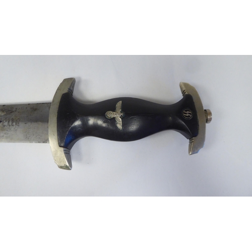 126 - A Third Reich era 'chained' SS dress dagger with a shaped handgrip, nickel-silver mounts and a cross... 