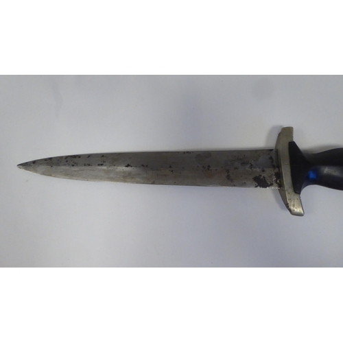 126 - A Third Reich era 'chained' SS dress dagger with a shaped handgrip, nickel-silver mounts and a cross... 