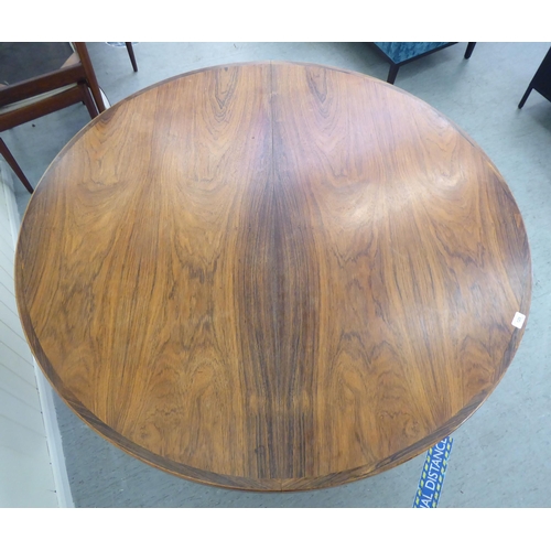 129 - A 1960s Danish Heltborg Mobler rosewood dining table with a two-part top, raised on an angled base  ... 