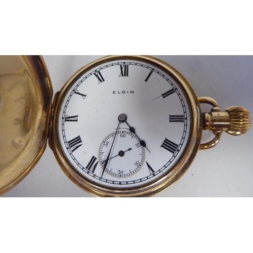 13 - A 9ct gold cased half-hunter pocket watch, the movement faced by a white enamel Roman dial, incorpor... 