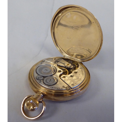 13 - A 9ct gold cased half-hunter pocket watch, the movement faced by a white enamel Roman dial, incorpor... 