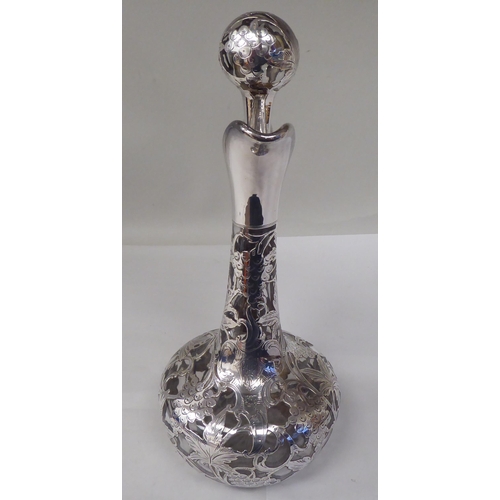 130 - A glass wine decanter of bottle form with a bulbous body, long, narrow neck, loop handle and stopper... 