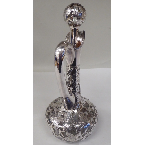 130 - A glass wine decanter of bottle form with a bulbous body, long, narrow neck, loop handle and stopper... 