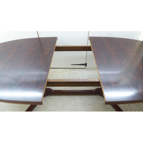 133 - Attributed to Robert Heritage for Archie Shine, a 1960s rosewood extending dining table, comprising ... 