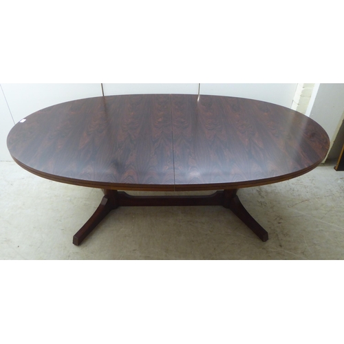 133 - Attributed to Robert Heritage for Archie Shine, a 1960s rosewood extending dining table, comprising ... 