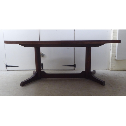 133 - Attributed to Robert Heritage for Archie Shine, a 1960s rosewood extending dining table, comprising ... 