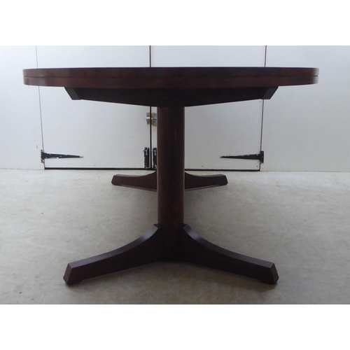 133 - Attributed to Robert Heritage for Archie Shine, a 1960s rosewood extending dining table, comprising ... 