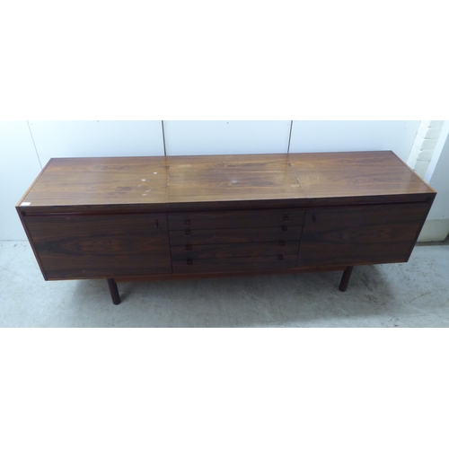 135 - Attributed to Robert Heritage for Archie Shine, a 1960s rosewood sideboard, the top with a rising an... 