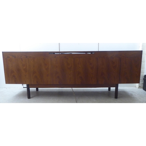 135 - Attributed to Robert Heritage for Archie Shine, a 1960s rosewood sideboard, the top with a rising an... 