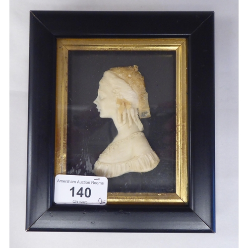 140 - A pair of 19thC carved wax head and shoulders profile portraits, a bewhiskered man and a young woman... 