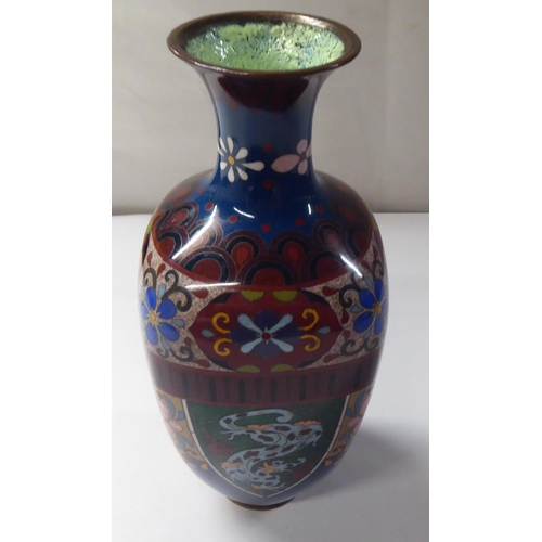 144 - An early 20thC cloisonné shouldered, baluster shape vase, decorated in colours and panels, de... 