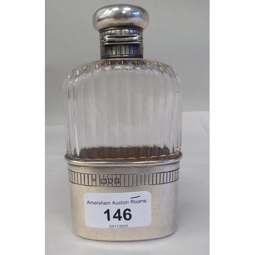 146 - A silver mounted, reed moulded glass hip flask with a detachable sleeve cup and outset hinged cap&nb... 