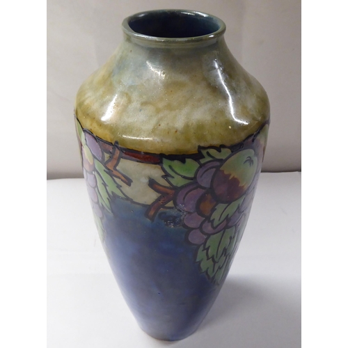 147 - An early 20thC Royal Doulton stoneware vase of shouldered, tapered form, decorated with soft fruit a... 