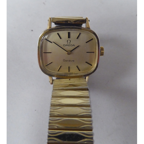 148 - A lady's Omega gold plated and stainless steel cased wristwatch, faced by a baton dial, on an expand... 