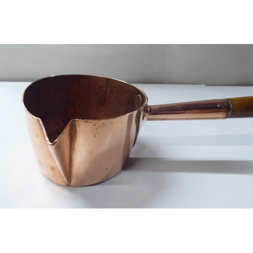 150 - A 19thC copper chocolate saucepan with a spout, rivetted and turned wooden handgrip  4.5