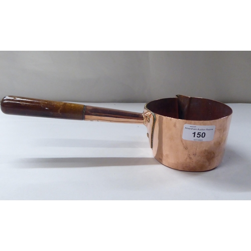 150 - A 19thC copper chocolate saucepan with a spout, rivetted and turned wooden handgrip  4.5