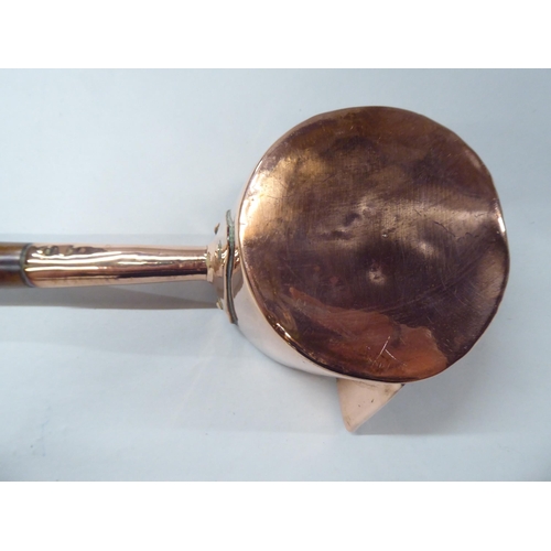 150 - A 19thC copper chocolate saucepan with a spout, rivetted and turned wooden handgrip  4.5