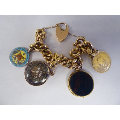 169 - A 9ct gold belcher link charm bracelet: to include a locket; a Victorian sovereign, St. George on th... 