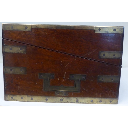 17 - A Victorian mahogany military style writing box with lacquered brass mounts and reinforcement, strai... 