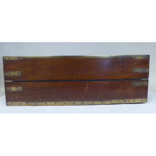 17 - A Victorian mahogany military style writing box with lacquered brass mounts and reinforcement, strai... 