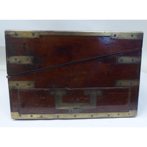 17 - A Victorian mahogany military style writing box with lacquered brass mounts and reinforcement, strai... 