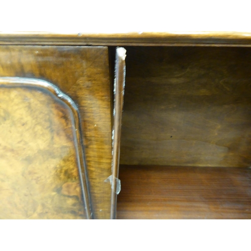 172 - A late Victorian mahogany bookcase with carved mask ornament and two glazed doors, on a plinth ... 