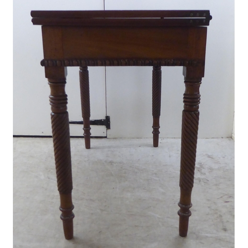 173 - An early 19thC mahogany tea table with a foldover top, raised on turned ropetwist legs  31