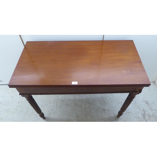 173 - An early 19thC mahogany tea table with a foldover top, raised on turned ropetwist legs  31