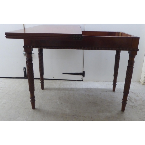 173 - An early 19thC mahogany tea table with a foldover top, raised on turned ropetwist legs  31