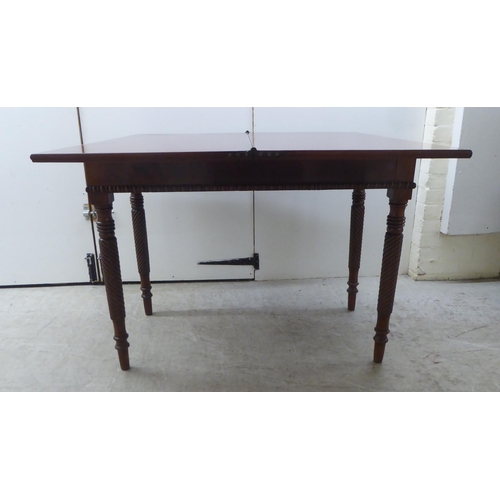 173 - An early 19thC mahogany tea table with a foldover top, raised on turned ropetwist legs  31