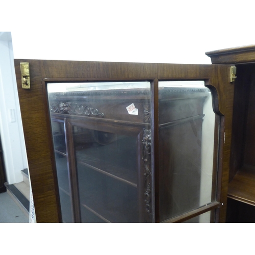 176 - A mid 20thC walnut bookcase with two glazed doors and two panelled doors, raised on cabriole legs&nb... 