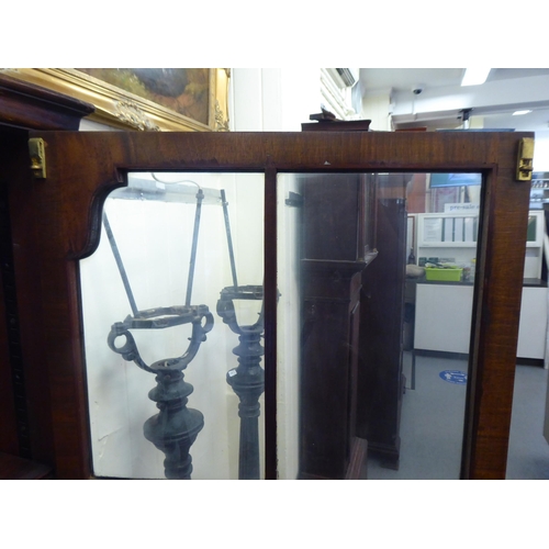 176 - A mid 20thC walnut bookcase with two glazed doors and two panelled doors, raised on cabriole legs&nb... 